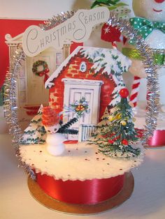 three christmas stockings hanging on a brick wall next to a tree with lights and ornaments