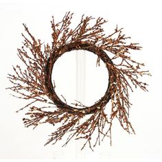 a wreath with dried branches hanging from it