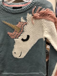 a sweater with an image of a unicorn on it