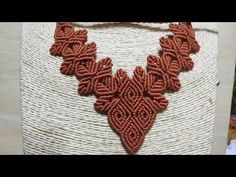 a red beaded necklace sitting on top of a white basket