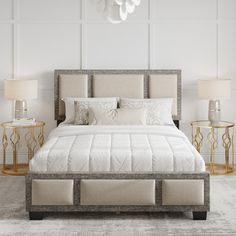 a white bed sitting in a bedroom next to two tables with lamps on top of them