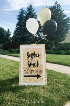 some balloons are in the air near a sign that says sophiie and grad graduate