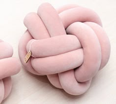 two pink donuts that have been made to look like a knotted knot on top of each other