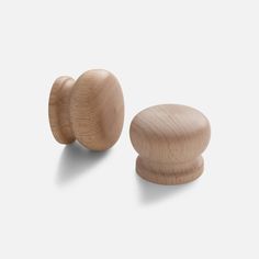 two wooden knobs are shown against a white background and one is turned to the side