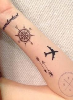 a person with a tattoo on their arm that has an airplane and compass tattoos on it