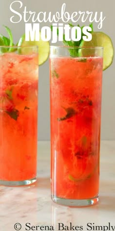 two glasses filled with watermelon mojits and lime wedged in the middle