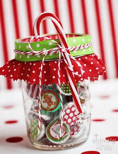 a glass jar filled with candy canes and the words check them off your list 8 printable gifts