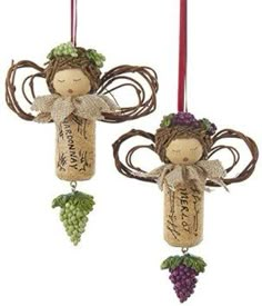 two wine cork angel ornaments hanging from strings