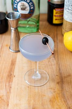 an alcoholic cocktail sitting on top of a wooden table