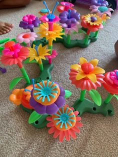 colorful plastic flowers are laying on the floor