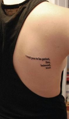 the back of a woman's shoulder with a quote on it