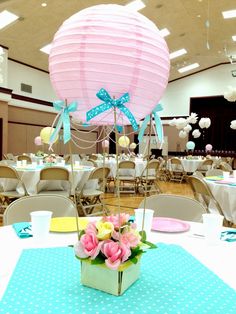 a table topped with a pink and blue balloon