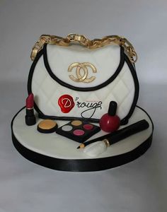 a chanel purse cake with makeup and lipstick