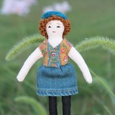 a doll is standing in the middle of tall grass