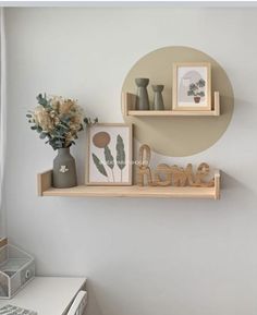 two shelves with pictures and vases on them