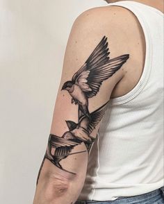 a man with a bird tattoo on his arm