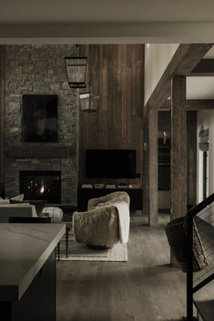 a living room filled with furniture and a fire place next to a wall mounted tv