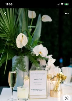 the table is set with flowers, candles and menu cards for guests to sign in