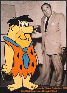 an old photo of a man standing next to a cartoon character in front of him