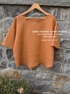 an orange t - shirt hanging on a stone wall with the words basic cropped tshirt pattern