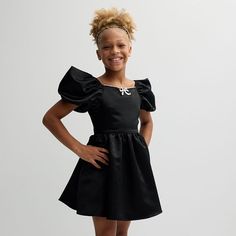 She'll be ready for any event in this girls' Rare Editions satin dress with bow trim. Click on this KIDS APPAREL & SHOES GUIDE to find the perfect fit and more! She'll be ready for any event in this girls' Rare Editions satin dress with bow trim. Click on this KIDS APPAREL & SHOES GUIDE to find the perfect fit and more! FEATURES Squareneck Short puff sleeves Zipper closure Above the knee length Regular fit Satin construction Features bow trimFABRIC & CARE Polyester Hand wash Imported Size: 16. C Black Dress With Bow, Shoes Guide, Girls Black Dress, Baby Size, Satin Dress, Dress With Bow, Above The Knee, Satin Dresses, Puff Sleeves