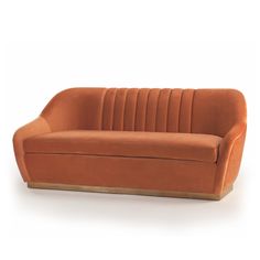 an orange couch sitting on top of a white floor