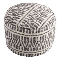 a black and white poufce with an intricate pattern on the top, sitting in front of a white background