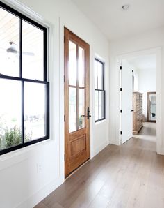 an instagram page on the iphone shows a white room with wooden doors and windows