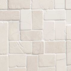 a white brick wall that is very close to the ground