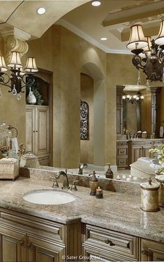 a large bathroom with double sinks and chandelier