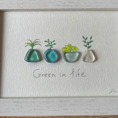 three framed stones with plants in them and the words green in life