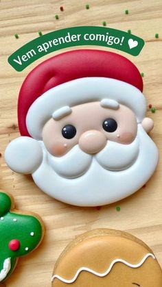 a close up of a cookie on a wooden table with santa clause and ginger cookies