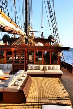 an outdoor lounge area on the deck of a large sailing ship with lots of seating