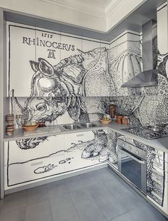 a kitchen with a mural painted on the wall