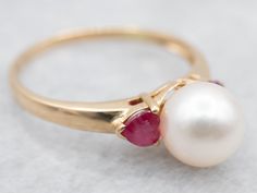 Unlock your inner royalty with this elegant ring! The warm yellow gold provides a perfect backdrop for the lustrous pearl and romantic heart shaped rubies. Put this luxurious ring on and you'll find yourself ruling the world!Metal: 14K Yellow GoldGem: PearlGem Measurements: 7.2 mm, RoundAccents: 2 Rubies Ring Size: 6.25Marks: "14K" Stamped on the inside band Dream Wedding Ring, Romantic Heart, Ring Ruby, Saltwater Pearls, Warm Yellow, White Gold Band, Elegant Ring, Ruby Ring, Gold Pearl