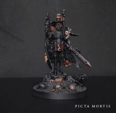 a painted warhammer with two swords and skulls on it's face, standing in front of a black background