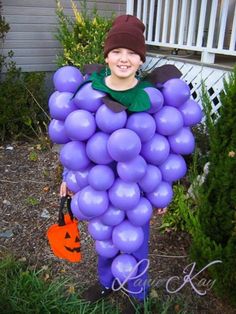 a young boy dressed up as a grape character