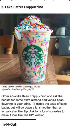 a cup with sprinkles on it sitting on top of a wooden table