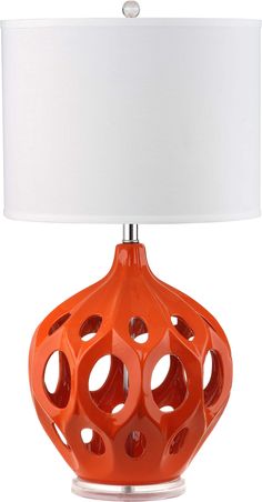 an orange table lamp with a white shade on the top and bottom part of it