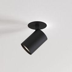 a black light fixture on a white wall with a dimmer in the middle and an overhead lamp above it