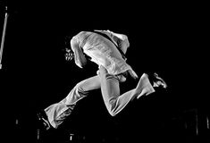 black and white photograph of a person jumping in the air