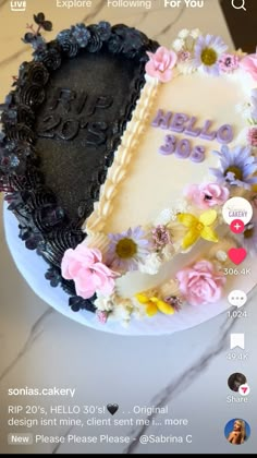 the cake is decorated with flowers and black icing