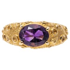 14k yellow gold ring. This striking ring has a horizontal, oval faceted, medium to dark purple color amethyst, approximately 1.42 CTS, prong set into a unique, moon crater style finished wide mounting. Marks: 14k Dimensions: 5/16" across the top x 3/16" wide Weight: 2.6 gross dwt Ring Size: 6.75 Dark Purple Color, Moon Surface, Yellow Gold Ring, Yellow Gold Rings, Dark Purple, Purple Color, Prong Setting, Gold Ring, Sapphire Ring