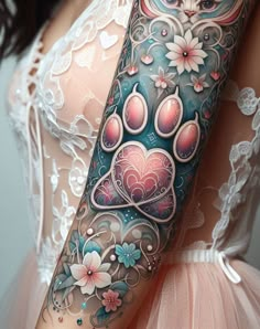 Show off your love for your furry companion with a tattoo that’s as loyal as they are. This paw print with a heart is for the eternal animal lover. Flowers And Paw Print Tattoo, Colorful Paw Tattoo, Random Tattoo Sleeve, Paw Prints And Flowers Tattoo, Flower Cat Tattoo, Colorful Paw Print Tattoo, Colorful Owl Tattoos For Women, Brother Tattoo, Paw Tattoos