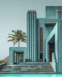 a large blue building with steps leading up to it and palm trees in the background