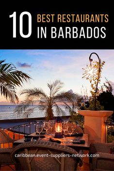 an outdoor dining area with tables and chairs, overlooking the ocean at sunset or sunrise