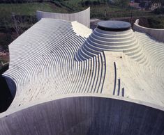 an aerial view of a concrete structure with wavy lines on the top and bottom part