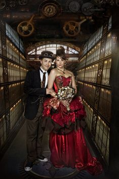 a man and woman are posing for a photo in an old fashioned jail cell area