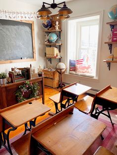 an empty classroom with desks and chairs in front of a chalkboard on the wall