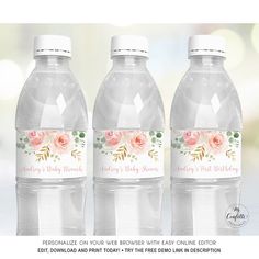 three water bottles with pink roses on the label are shown in front of a blurry background